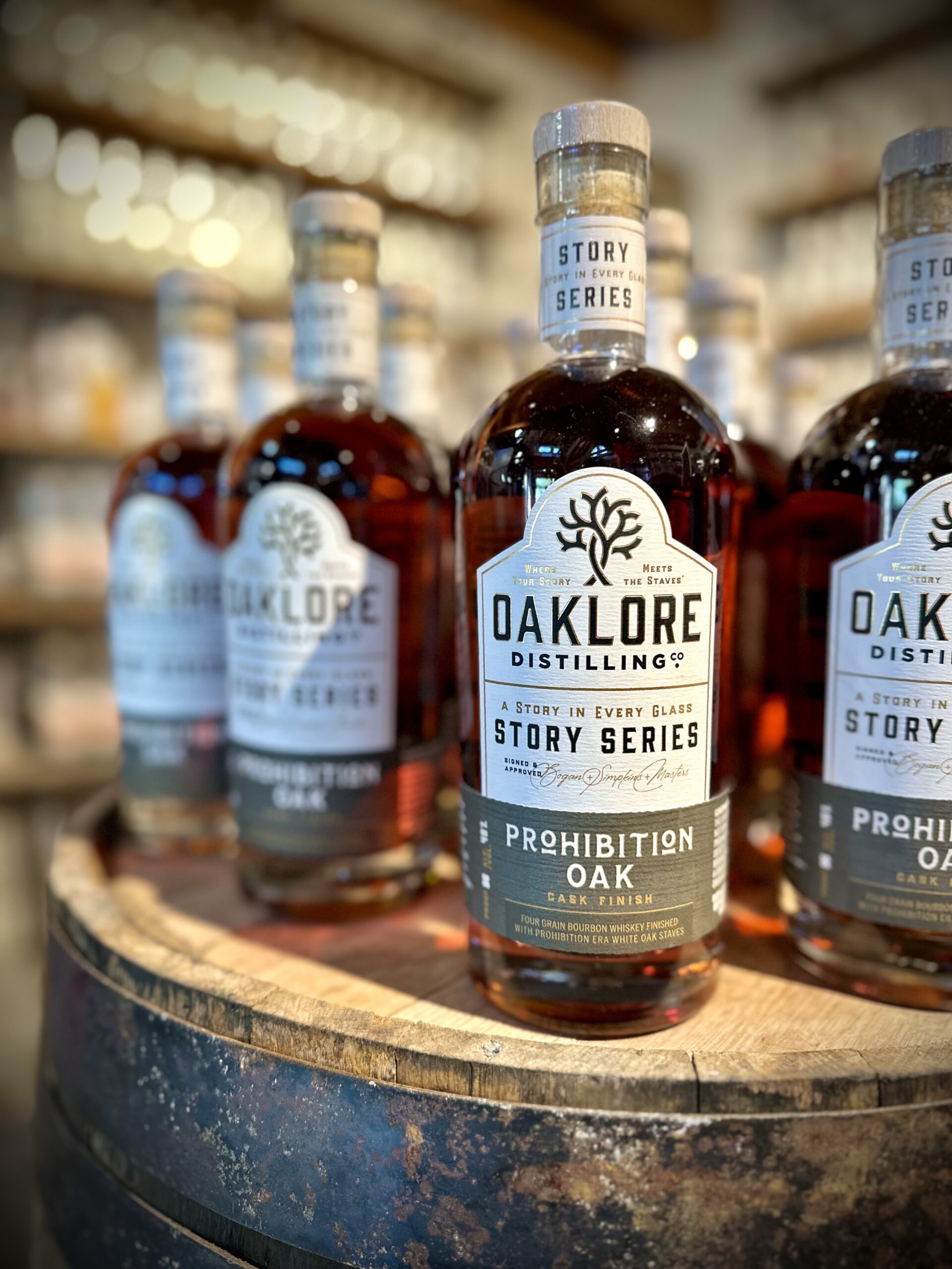 Oaklore Story Series Prohibition Oak Cask Finish bourbon bottles on a whiskey barrel